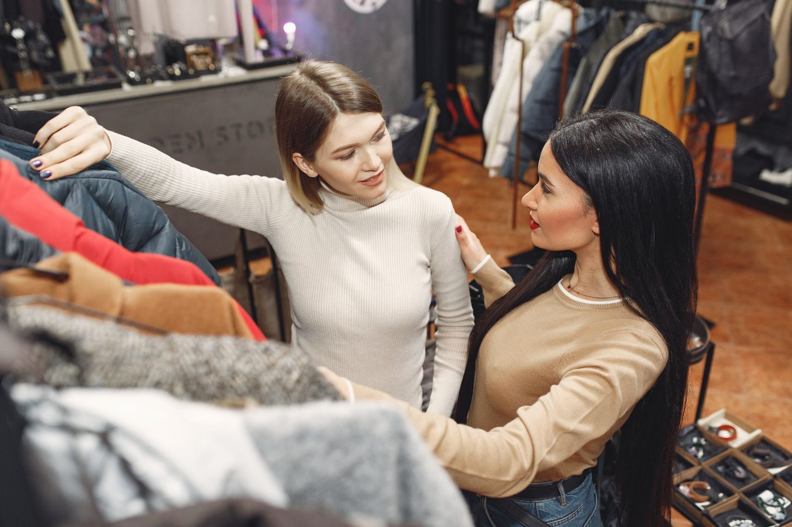 Two friends browsing clothes in a boutique